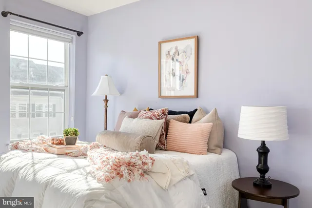 a bedroom with bed and a window