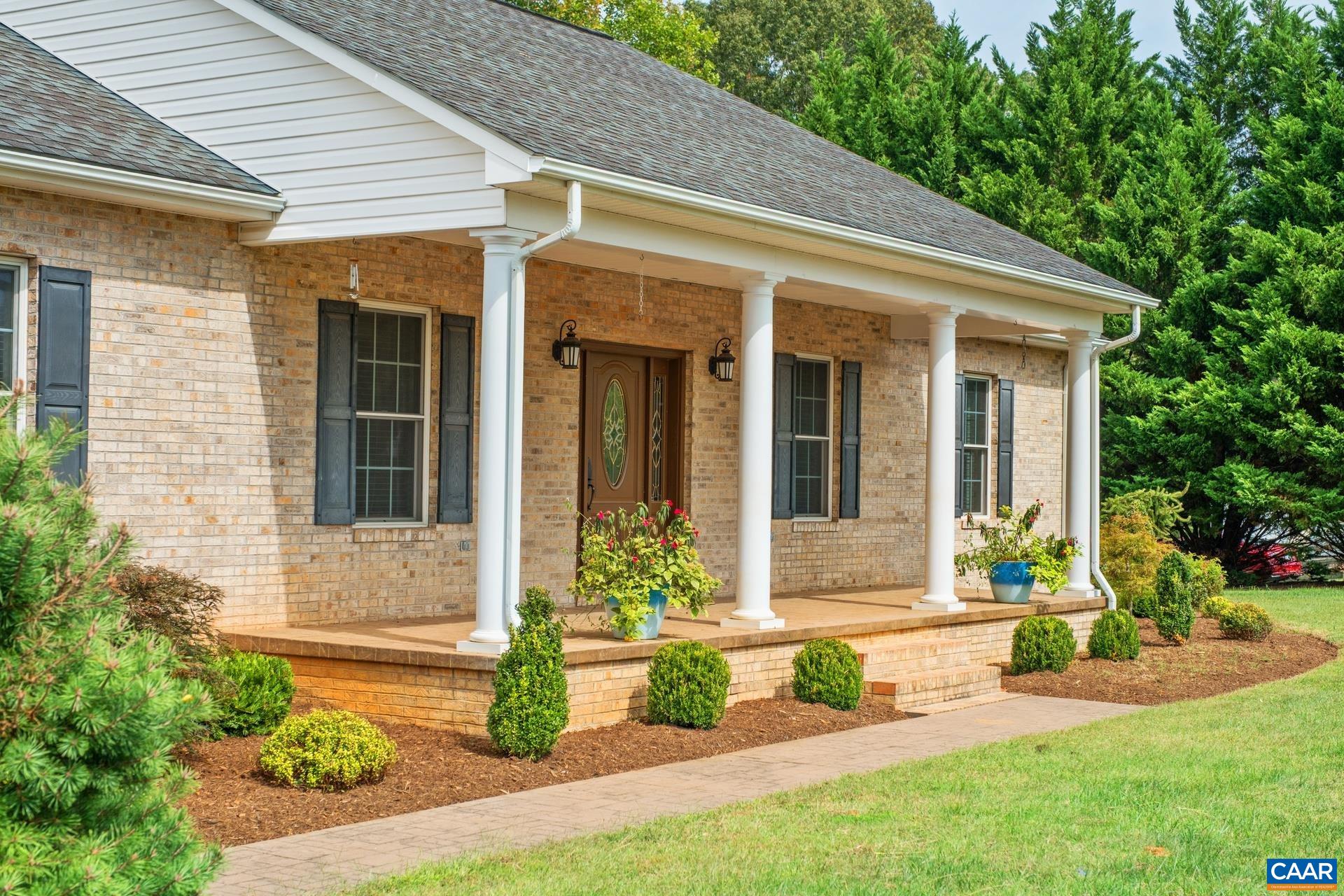 a front view of a house with a yard outdoor seating and garden