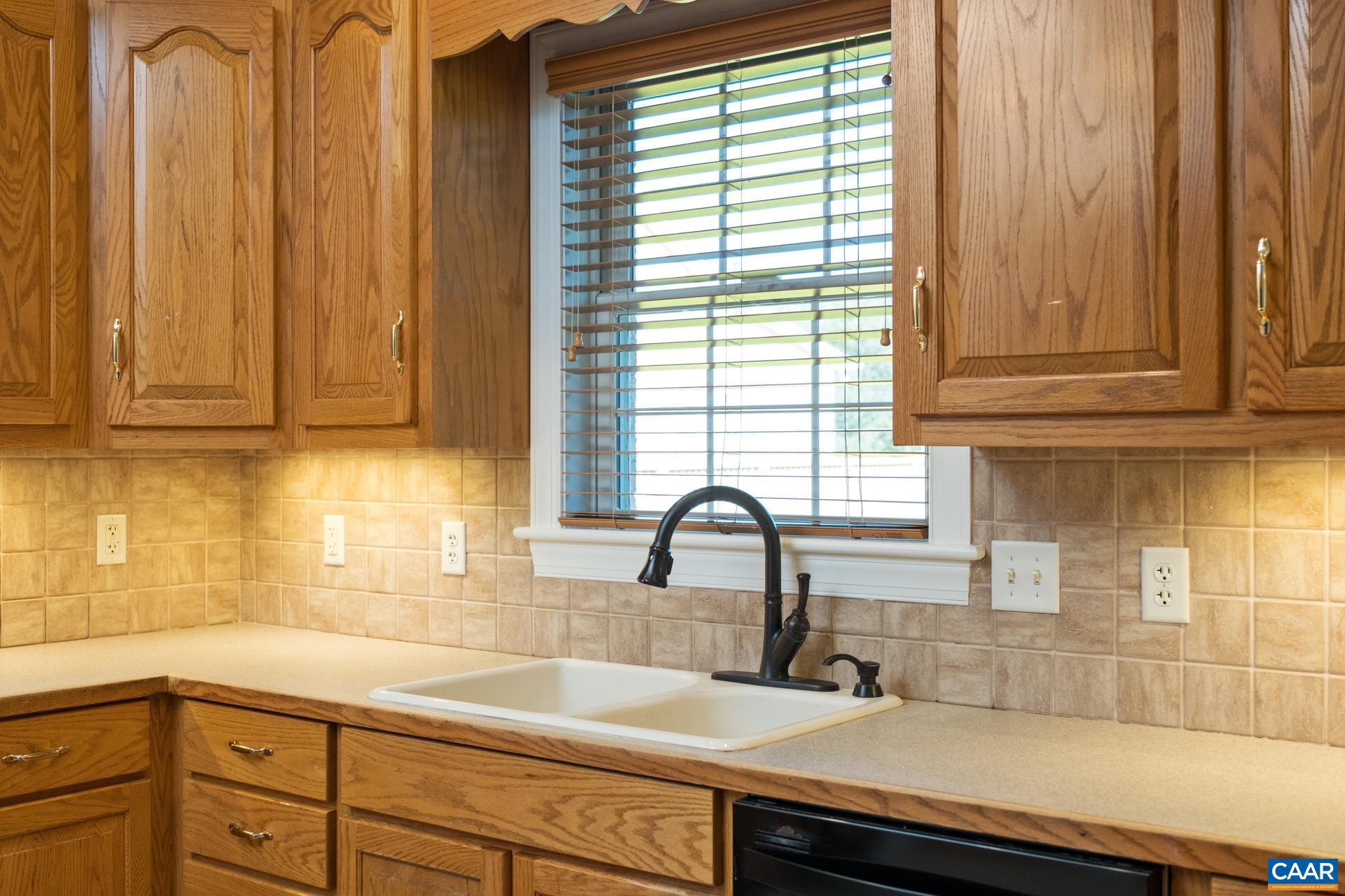 7550 Plank Road Afton, VA 22920 - Photo 15 of 49 a kitchen with stainless steel appliances wooden cabinets a sink and a window