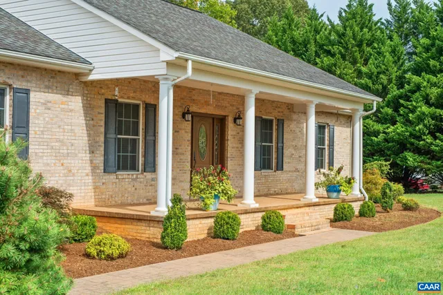 a front view of a house with a yard outdoor seating and garden