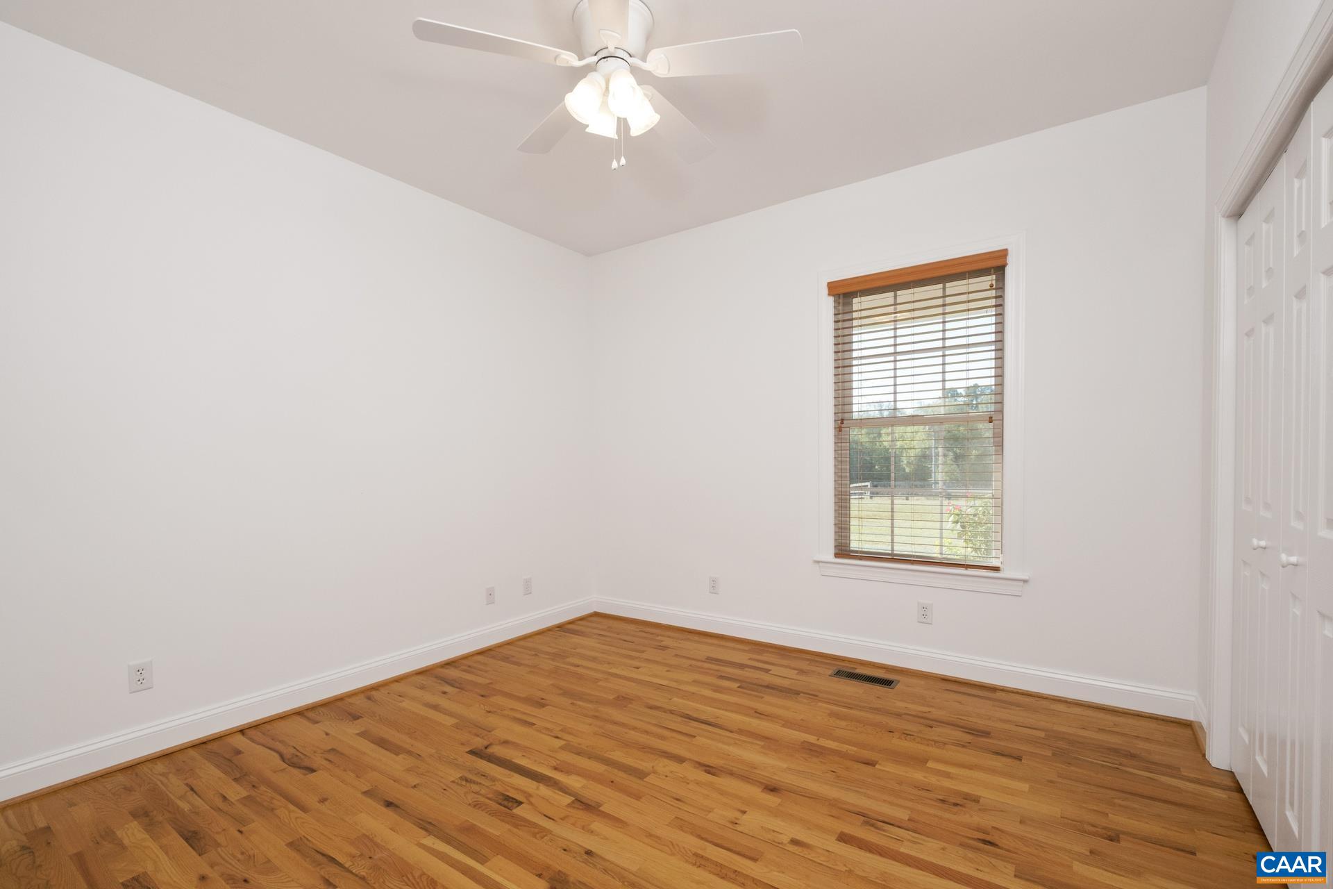 7550 Plank Road Afton, VA 22920 - Photo 23 of 49 an empty room with wooden floor and windows