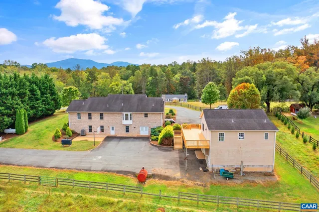 an aerial view of a house with swimming pool and garden