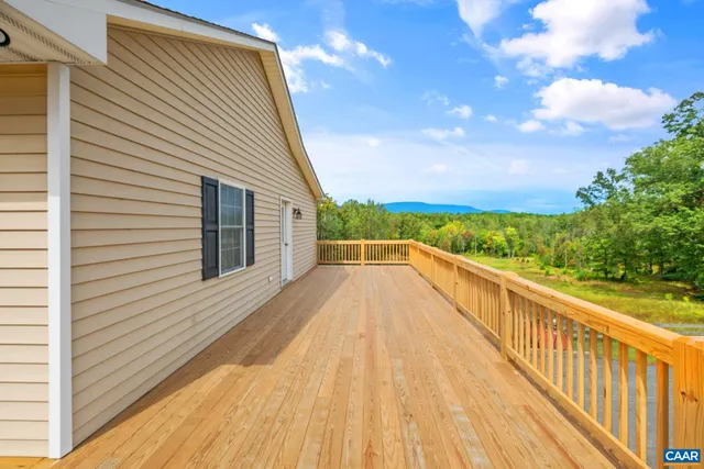 a view of balcony with wooden floor and fence