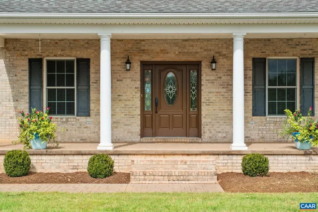 a front view of a house with potted plants
