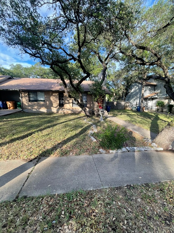 12613 Tree Line Drive, Unit A Austin, TX 78729 - Photo 1 of 15 a view of a yard in front of a house