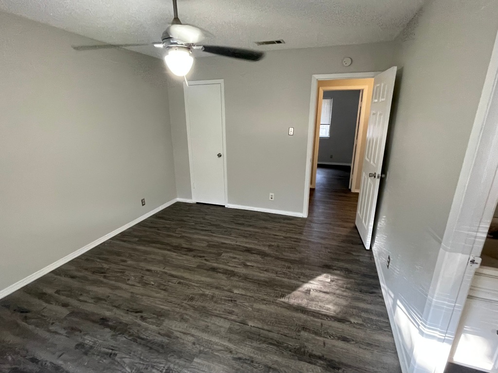 12613 Tree Line Drive, Unit A Austin, TX 78729 - Photo 11 of 15 a view of empty room with wooden floor