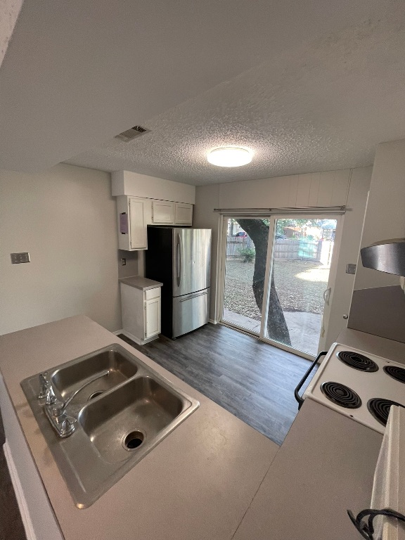 12613 Tree Line Drive, Unit A Austin, TX 78729 - Photo 12 of 15 a kitchen with a stove and a refrigerator