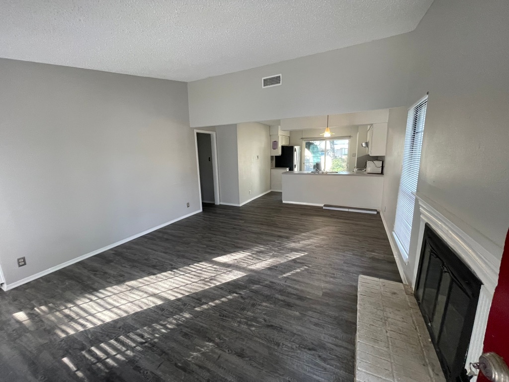12613 Tree Line Drive, Unit A Austin, TX 78729 - Photo 2 of 15 a view of empty room with wooden floor