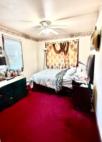 a bedroom with a bed dresser and a window