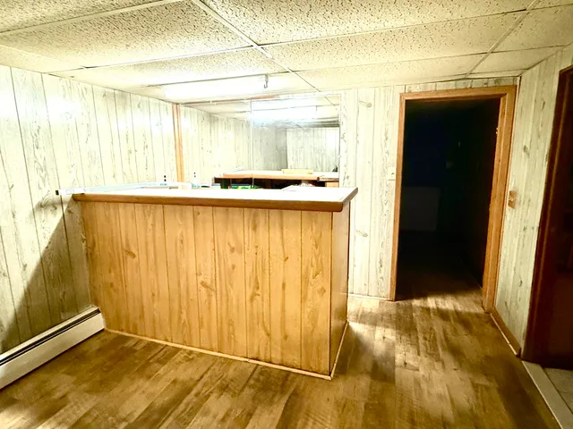 a view of a room with wooden floor and a window