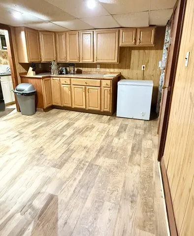 a kitchen with a sink stove and wooden cabinets