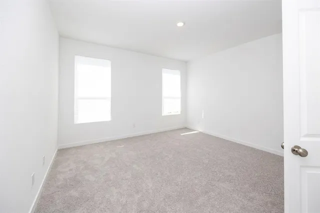 a view of a kitchen with a sink and dishwasher a refrigerator with white cabinets