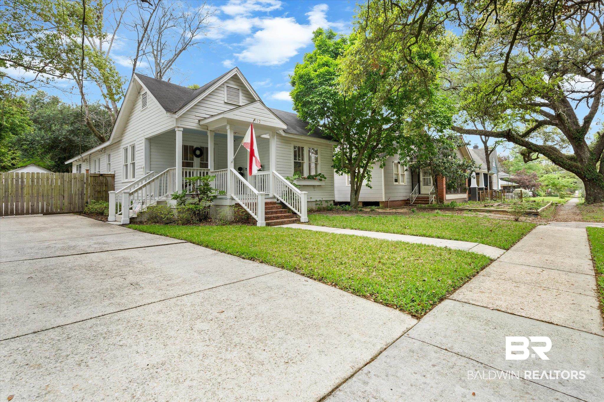 112 Crenshaw Street Mobile, AL 36606 - Photo 20 of 21 Bungalow-style house with driveway, fence, and a front lawn