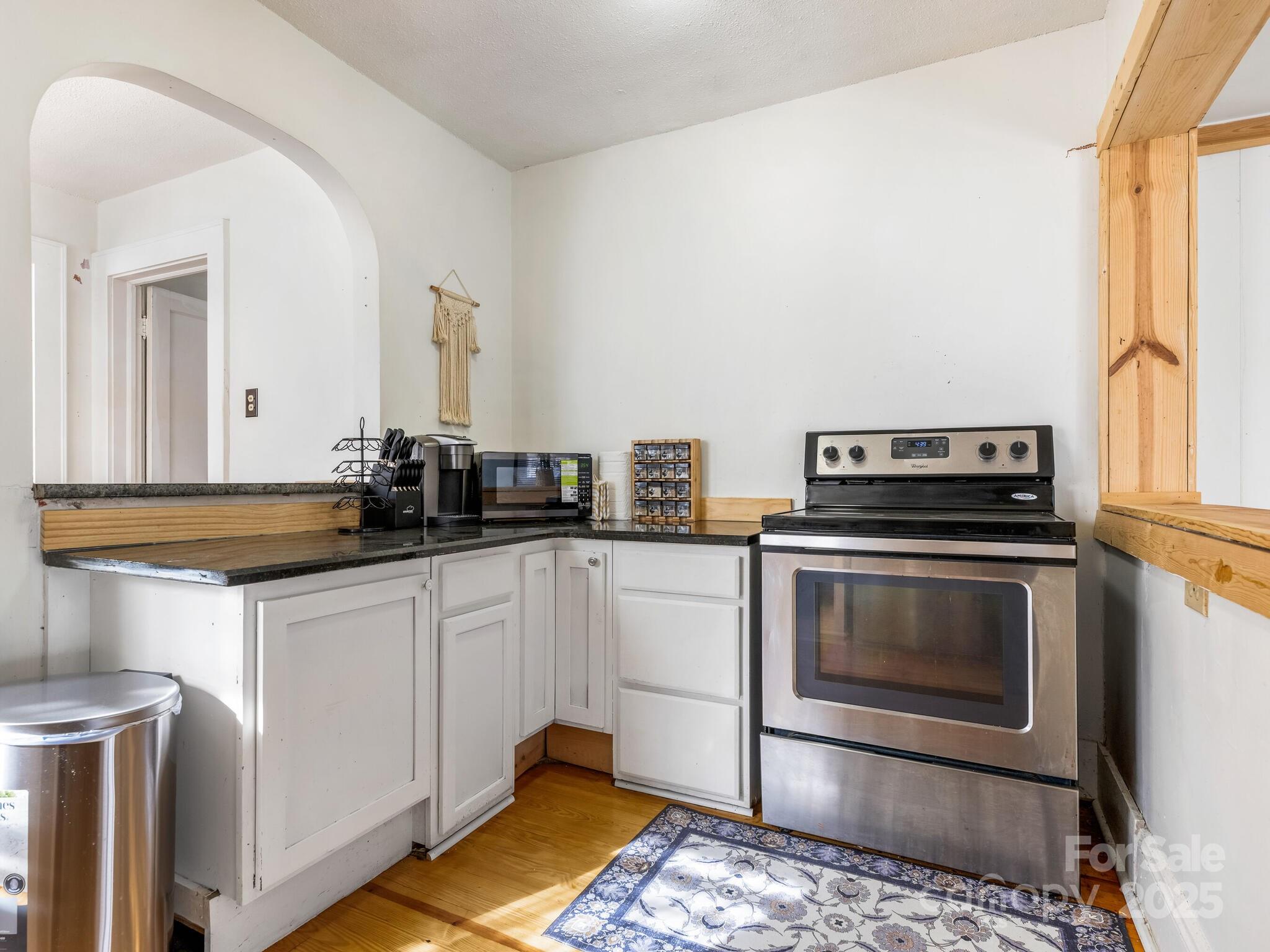 1008 Mable Avenue Kannapolis, NC 28083 - Photo 11 of 26 a kitchen with a stove and white cabinets