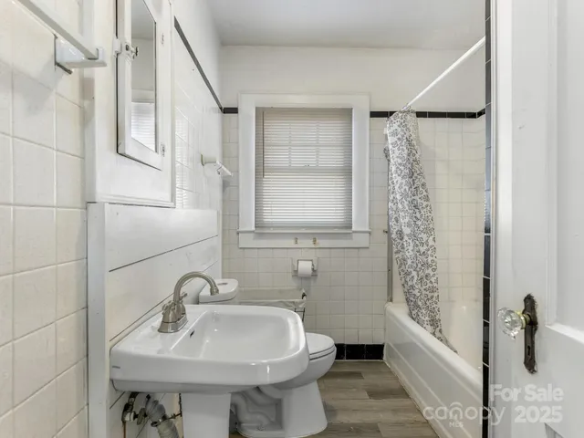 a bathroom with a sink toilet and tub