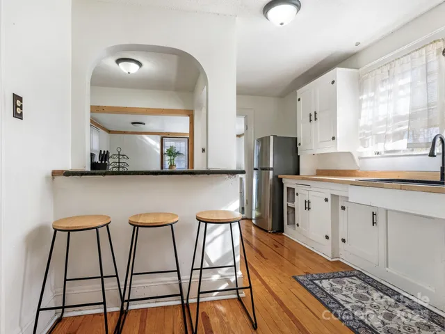 a kitchen with stainless steel appliances kitchen island granite countertop a sink and cabinets