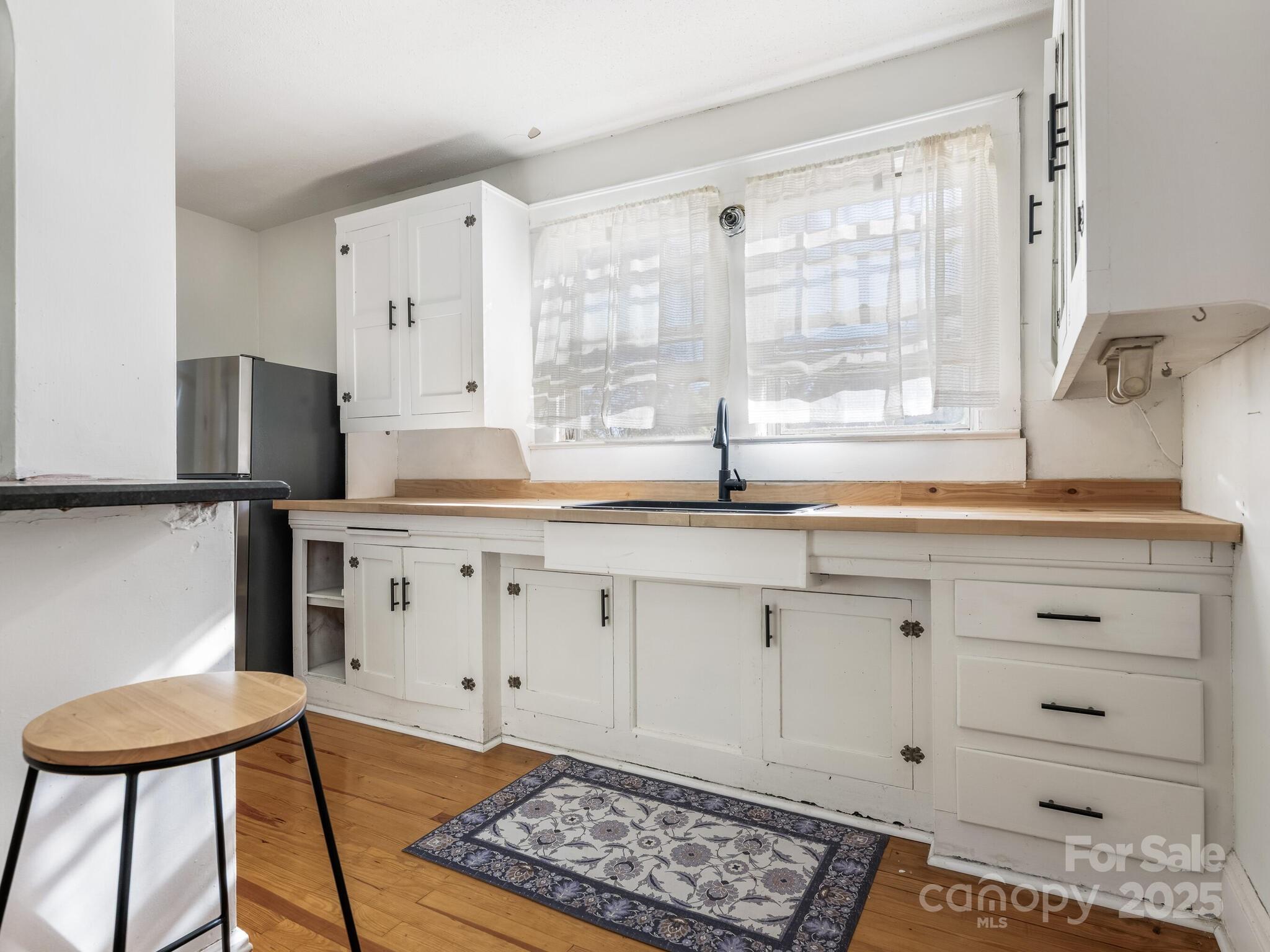 1008 Mable Avenue Kannapolis, NC 28083 - Photo 10 of 26 a kitchen with granite countertop a sink cabinets and stainless steel appliances