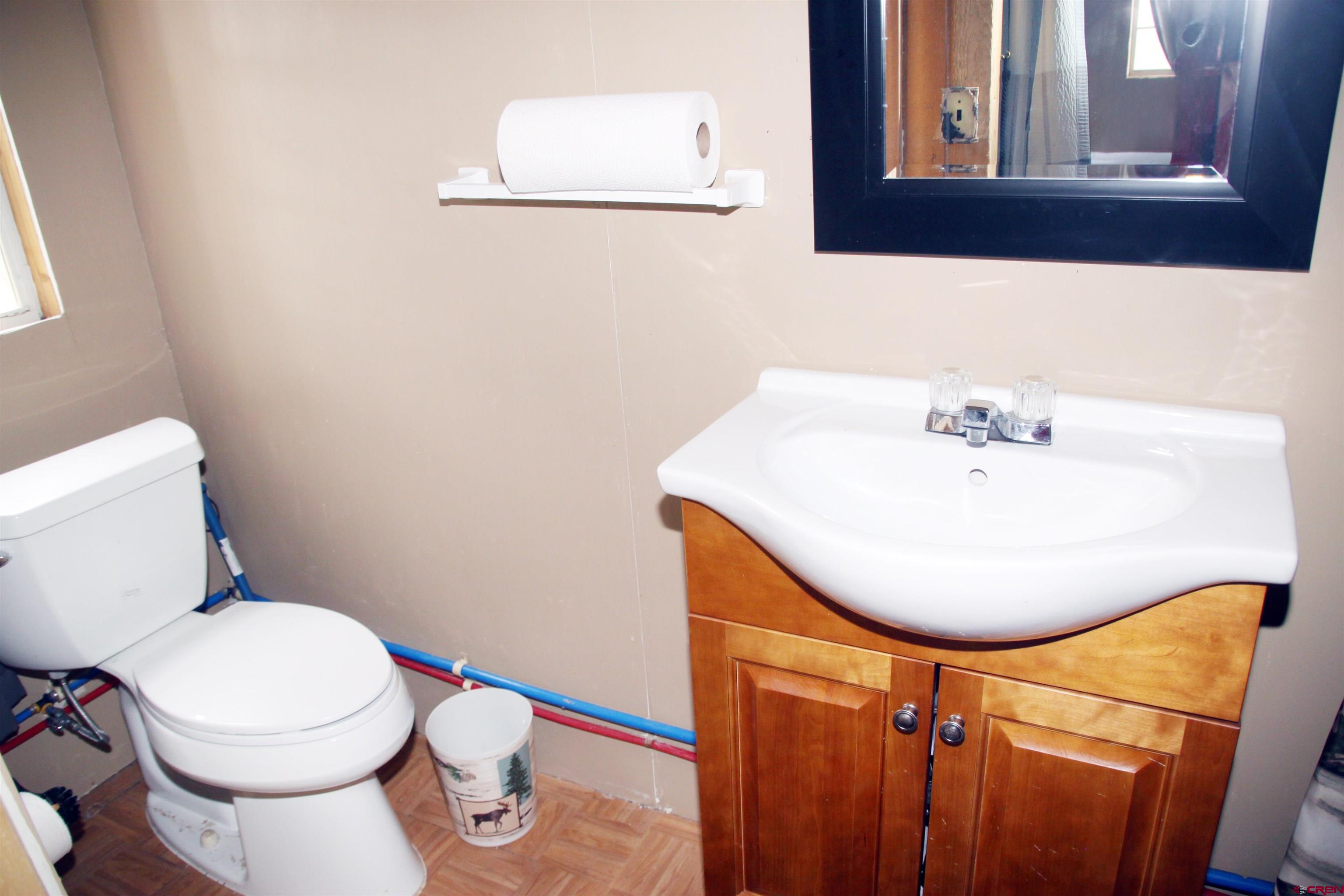 543 Justin's Road Pagosa Springs, CO 81147 - Photo 11 of 41 a bathroom with a sink mirror and toilet