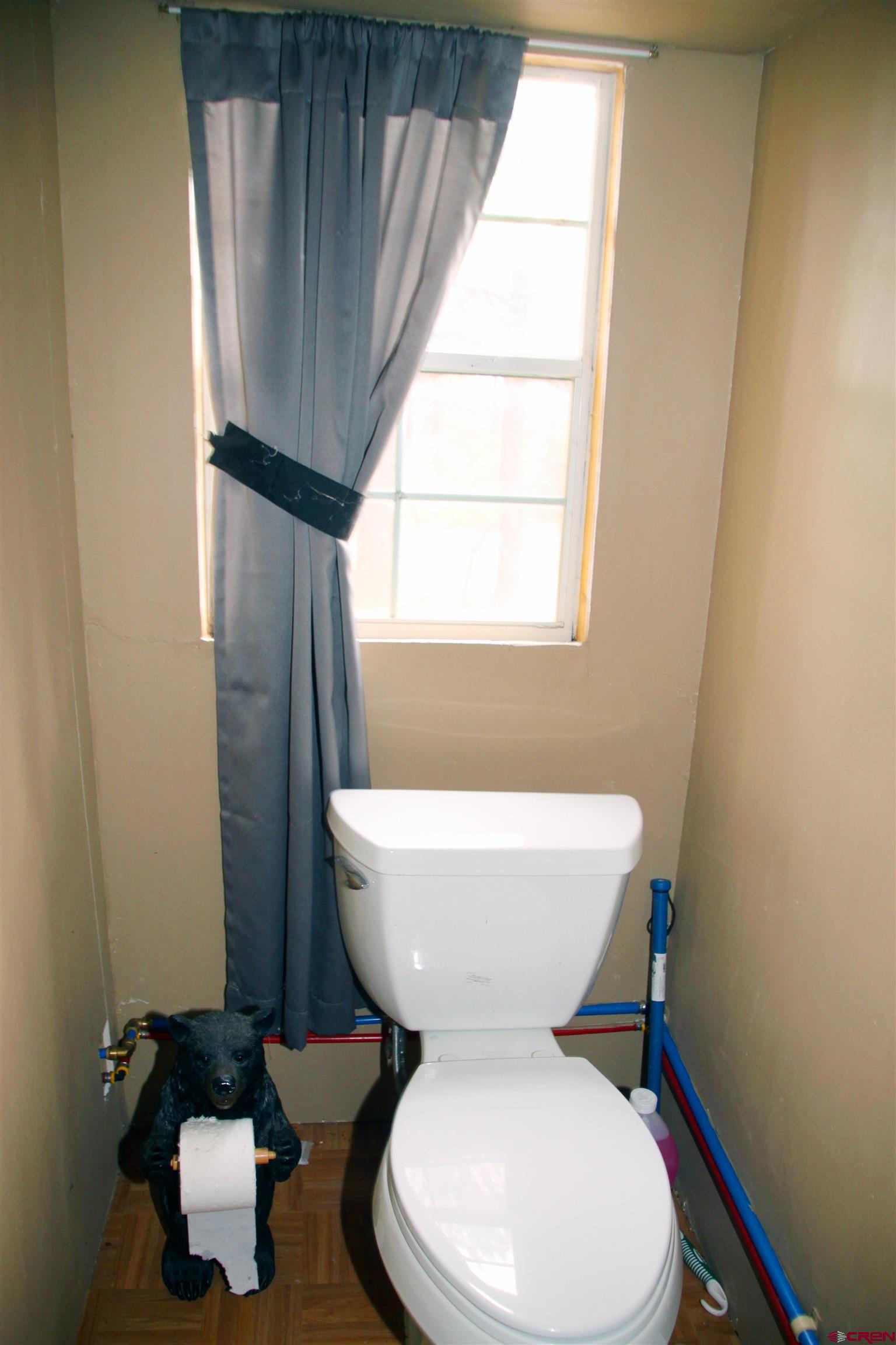 543 Justin's Road Pagosa Springs, CO 81147 - Photo 12 of 41 a white toilet sitting next to a window