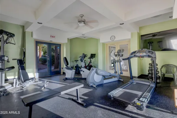 a room with gym equipment and view of living room