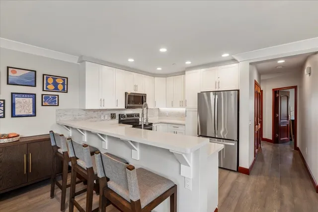 a large kitchen with a table and chairs