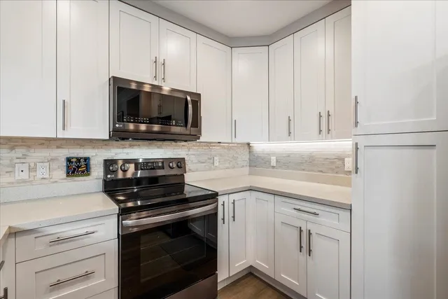 a kitchen with a sink and a stove top oven