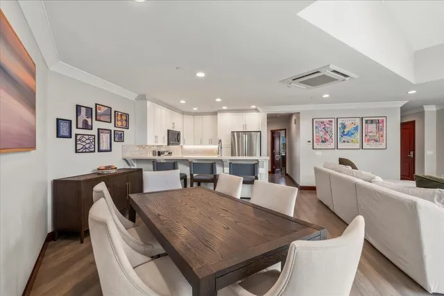 a view of a dining room with furniture window and wooden floor