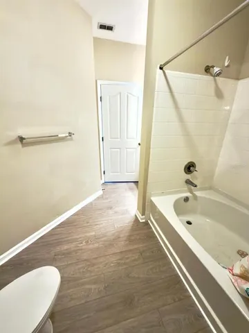 a bathroom with a tub a toilet and a sink