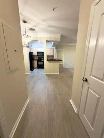 a view of kitchen with sink and refrigerator