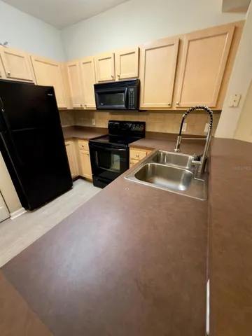 a kitchen with a sink and a refrigerator