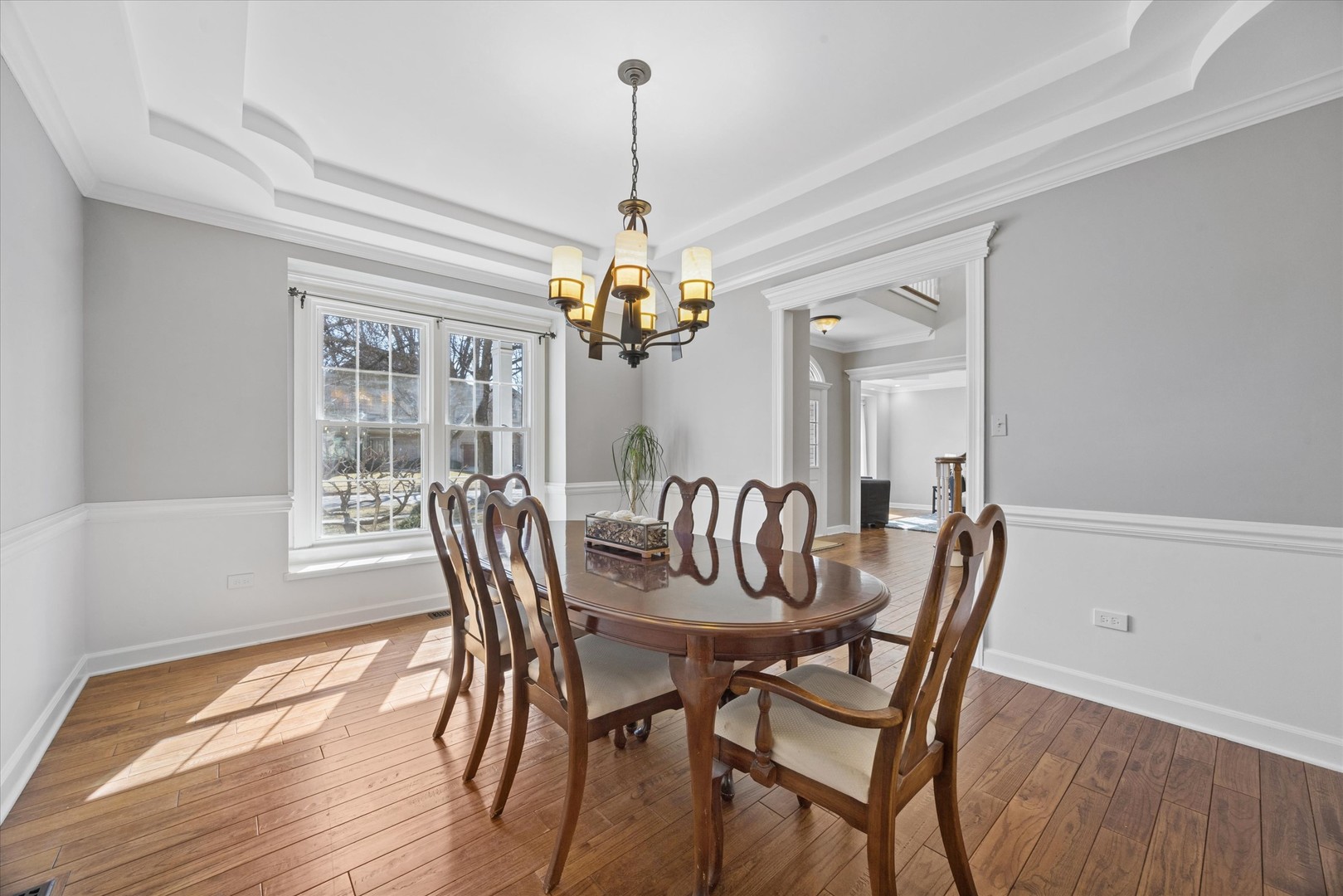 2711 Wendy Road Naperville, IL 60565 - Photo 15 of 49 a dining room with furniture a chandelier and wooden floor