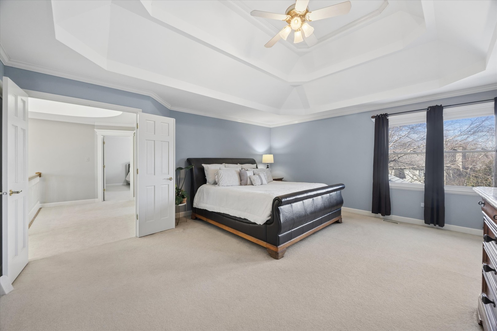 2711 Wendy Road Naperville, IL 60565 - Photo 20 of 49 a bedroom with a bed and a chandelier