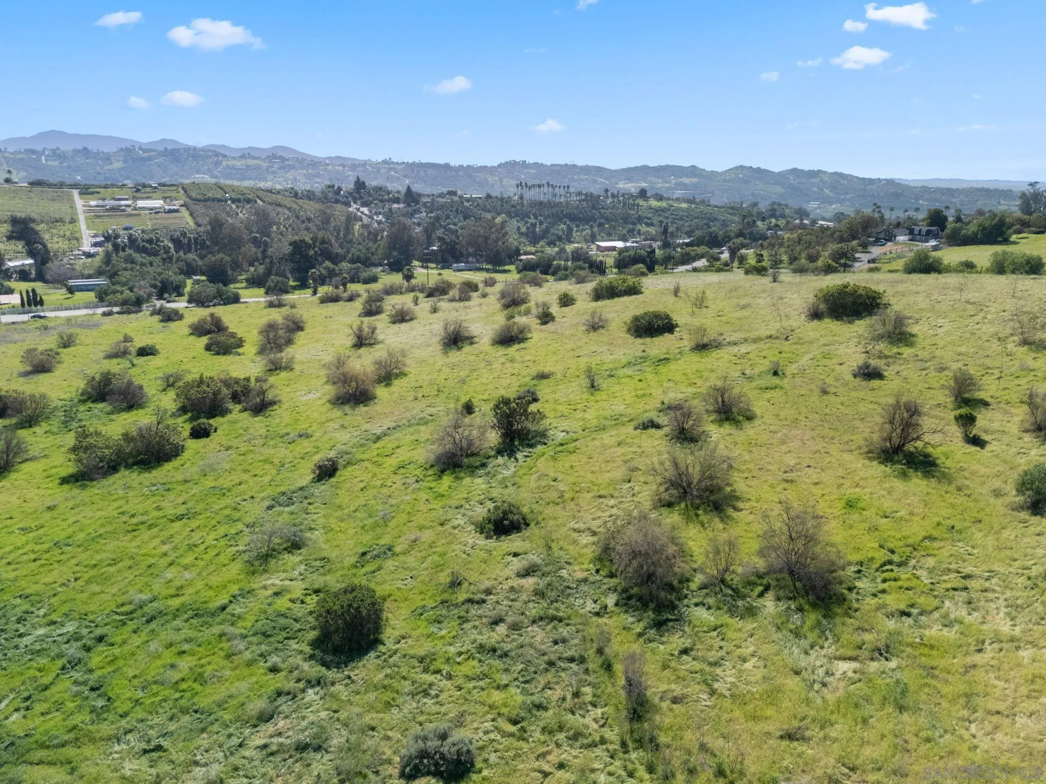 0 West Lilac Road, Unit 20 Bonsall, CA 92003 - Photo 12 of 18 a view of a green field with mountains in the background
