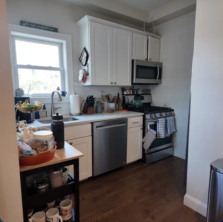 7 Loring Street, Unit 2 Boston, MA 02127 - Photo 2 of 10 a kitchen with a sink cabinets and window