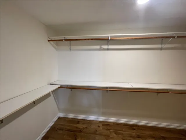 a view of storage and utility room with wooden floor