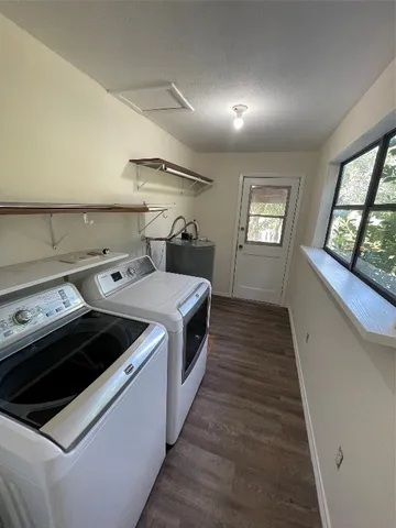 a kitchen with a stove and a wooden floor
