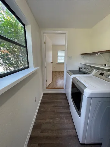 a view of washer and dryer with wooden floor