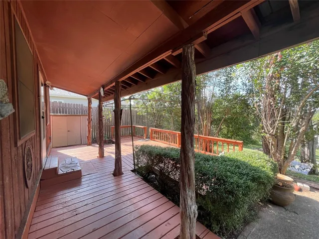 a view of a balcony with wooden floor