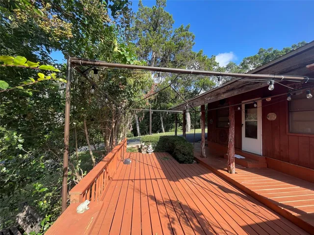 a view of balcony with wooden floor and outdoor seating