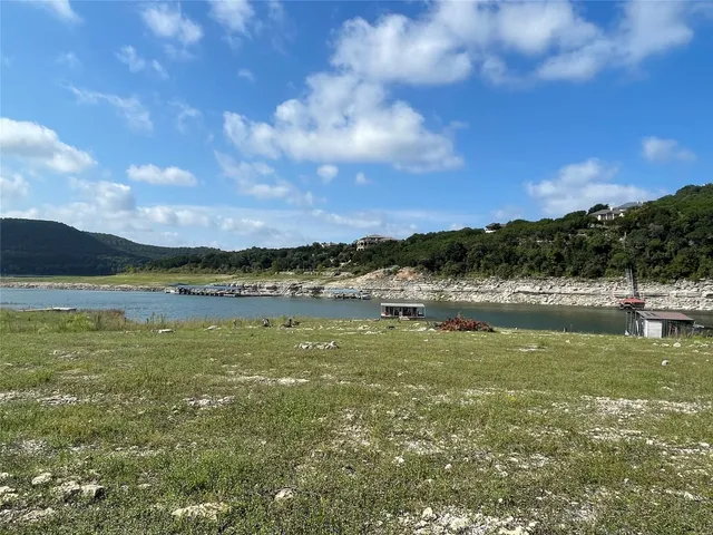 a view of a lake with houses in the back