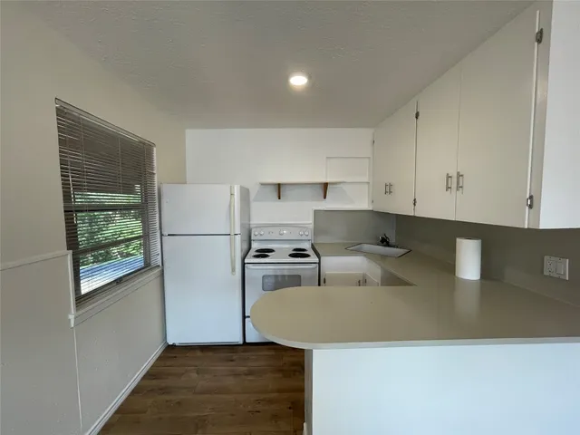 a kitchen with a sink a stove and refrigerator