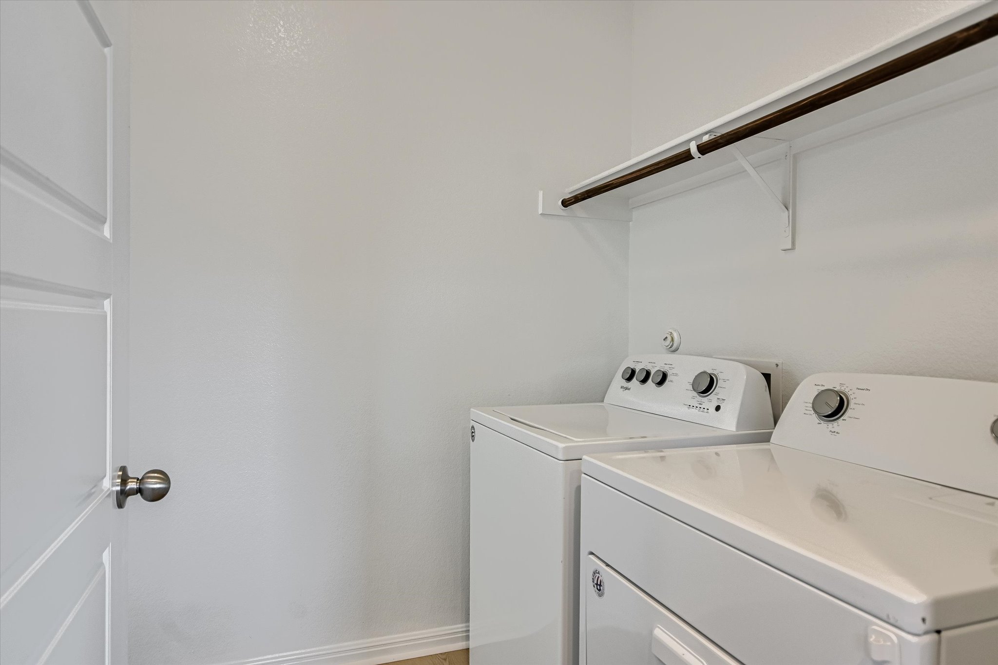 10317 Laurie Lane Austin, TX 78747 - Photo 10 of 27 The laundry room features a full-size washer and dryer and a large bonus storage space under the stairs.