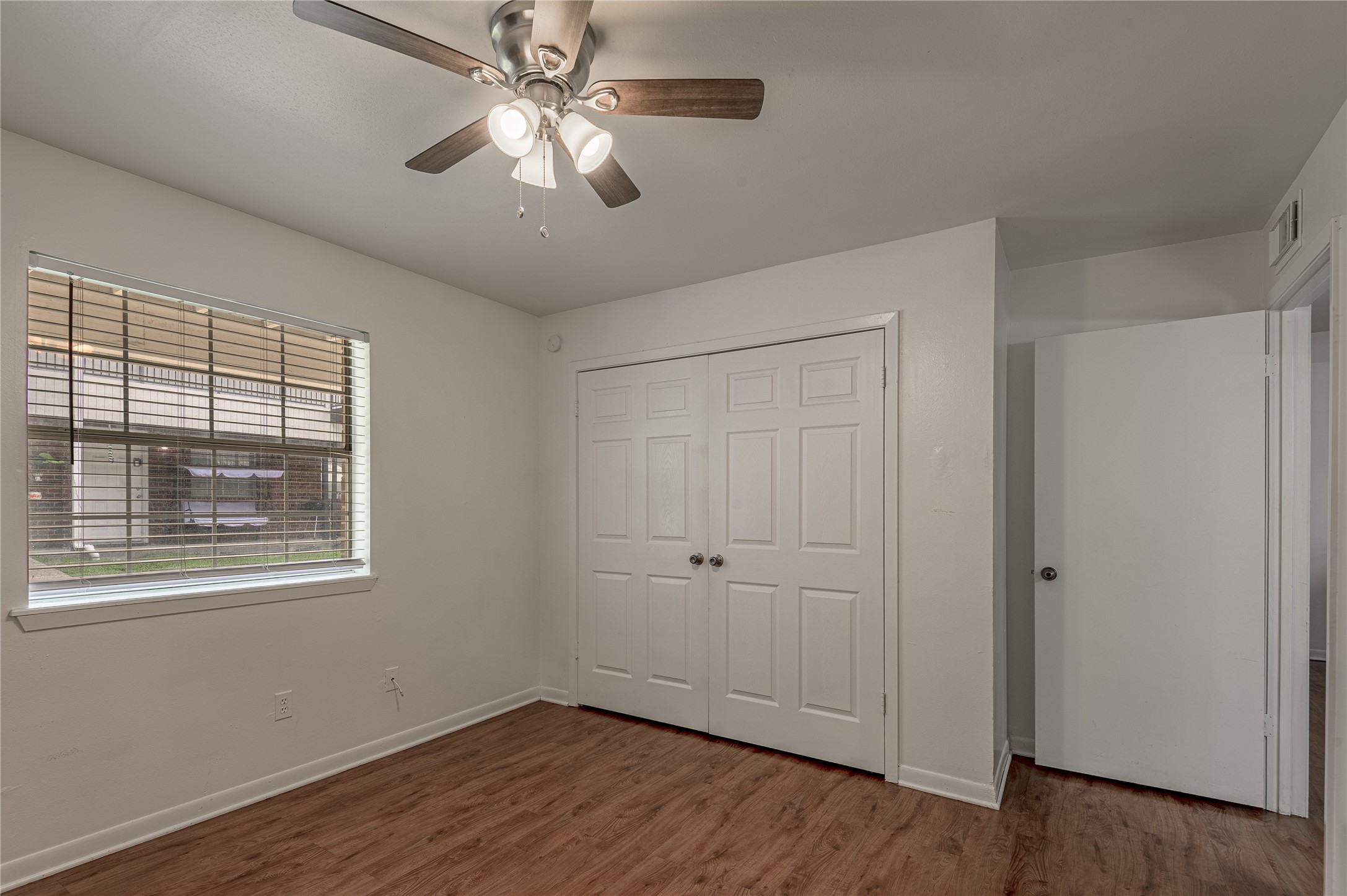 600 Palm Street, Unit 12 Huntsville, TX 77340 - Photo 13 of 23 a view of empty room with wooden floor and fan