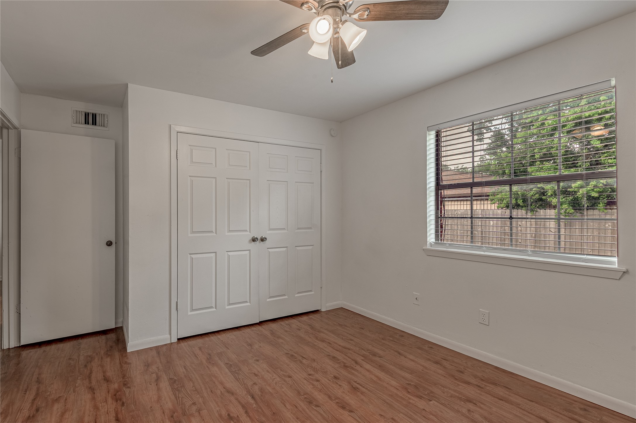 600 Palm Street, Unit 12 Huntsville, TX 77340 - Photo 17 of 23 a view of an empty room with wooden floor and a window