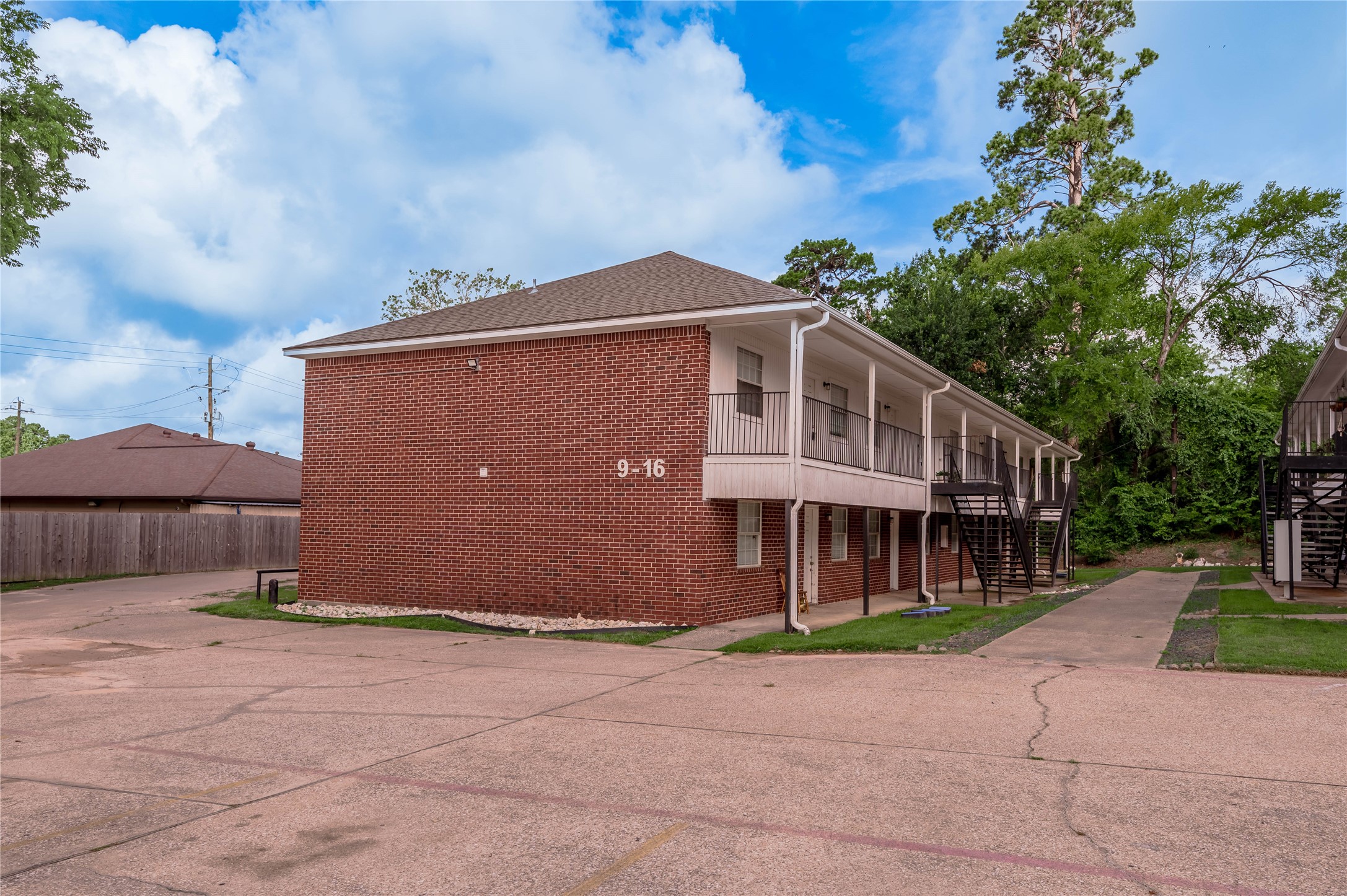 600 Palm Street, Unit 12 Huntsville, TX 77340 - Photo 19 of 23 a front view of a house with a yard and garage