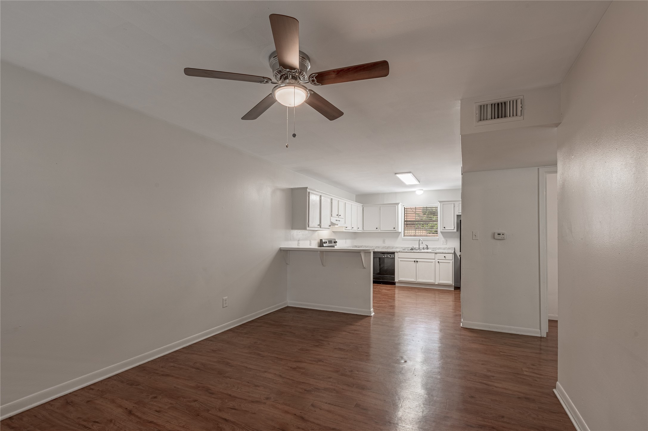 600 Palm Street, Unit 12 Huntsville, TX 77340 - Photo 5 of 23 a view of a kitchen with a sink and wooden floor