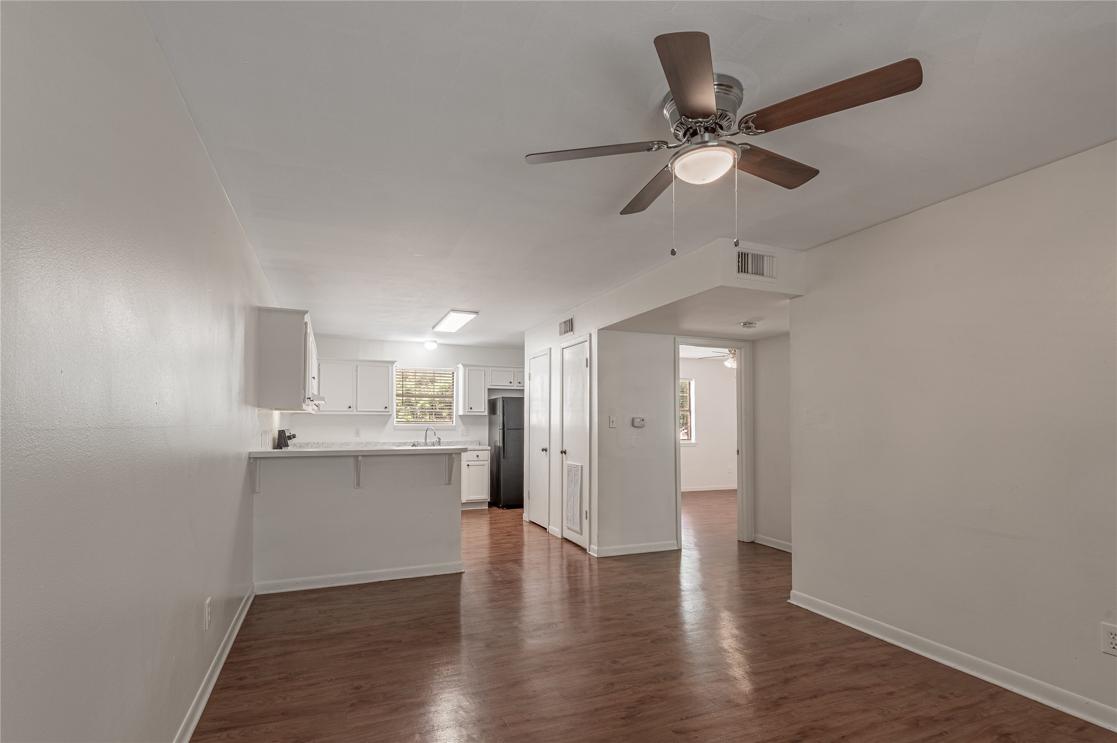 600 Palm Street, Unit 12 Huntsville, TX 77340 - Photo 6 of 23 a view of a kitchen with a sink dishwasher a refrigerator and wooden floor