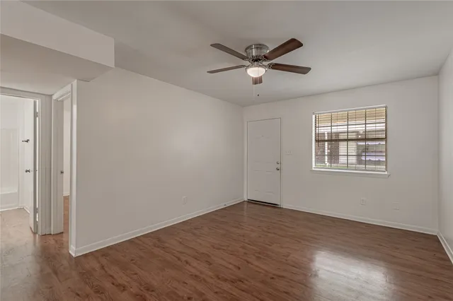 a view of a big room with wooden floor closet and windows