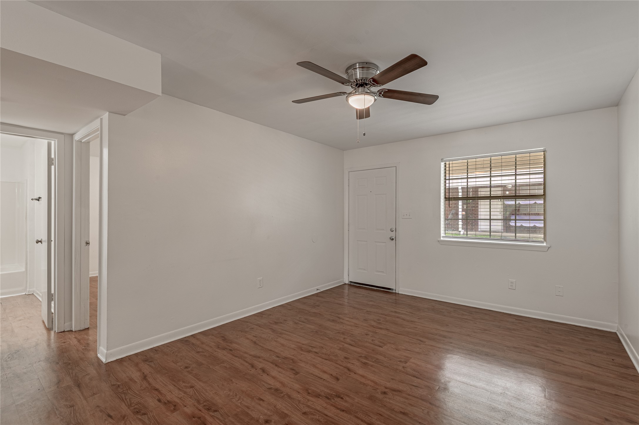 600 Palm Street, Unit 12 Huntsville, TX 77340 - Photo 7 of 23 a view of a big room with wooden floor closet and windows