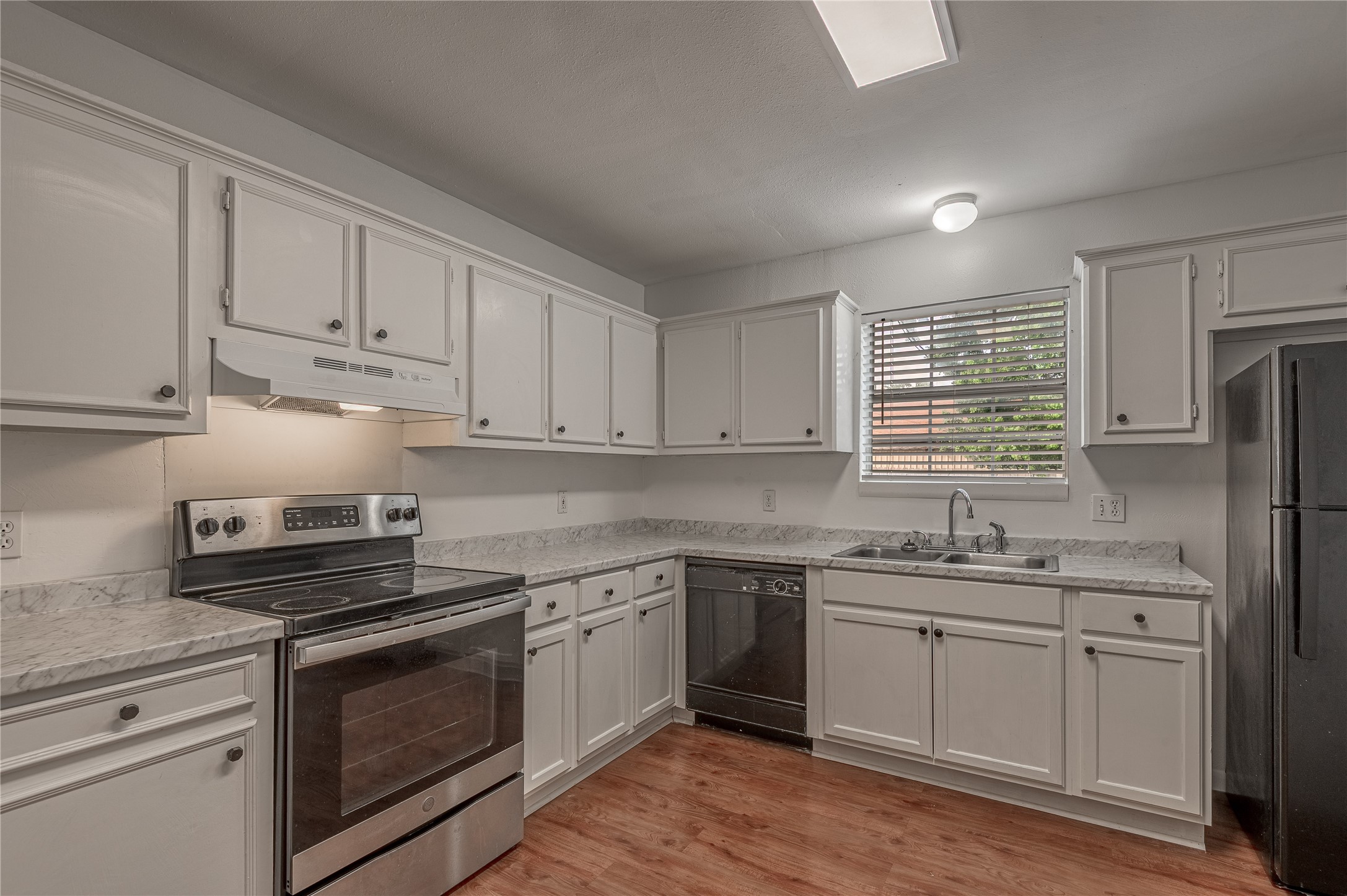 600 Palm Street, Unit 12 Huntsville, TX 77340 - Photo 9 of 23 a kitchen with appliances cabinets and a sink